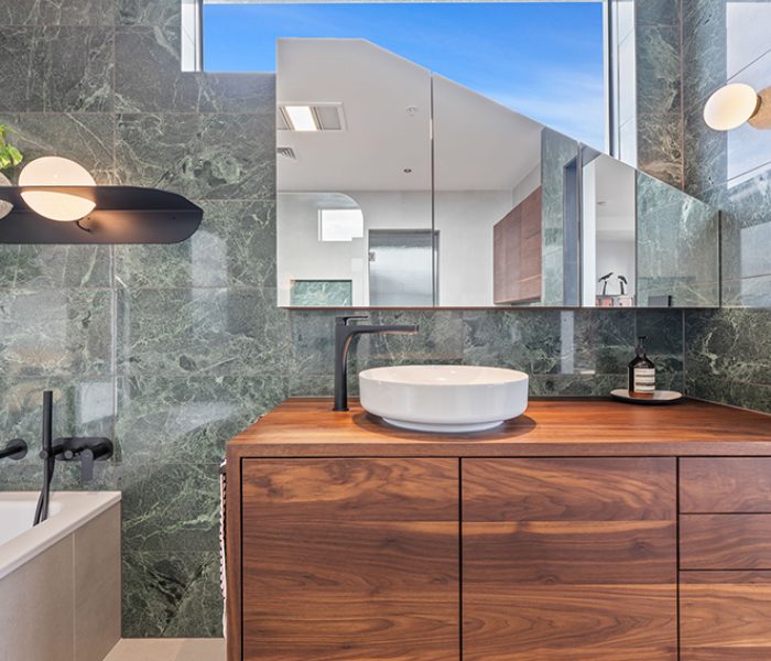 A beautiful modern bathroom with timber vanity and large tiles