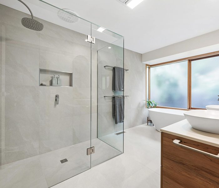 A minimalist bathroom with frameless shower and lots of natural light