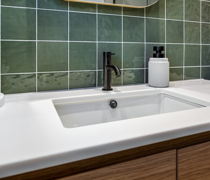 Dingley Village bathroom with frameless glass shower, recessed niches, freestanding bath and matte black tapware.